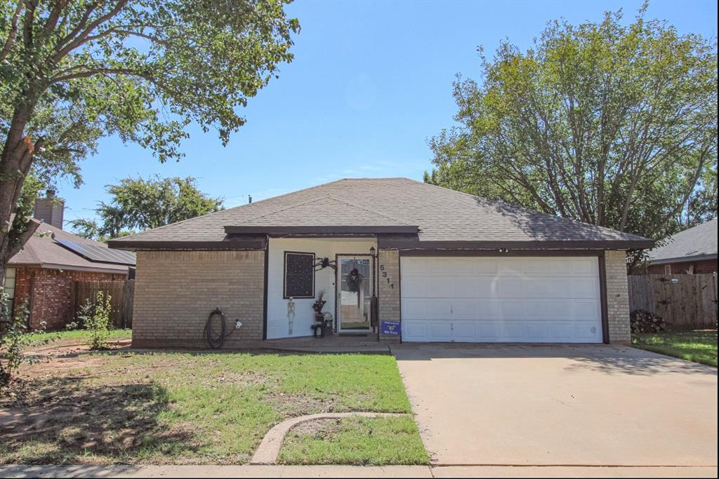 Ranch-style house featuring brick siding, driveway, an attached garage, and a shingled roof