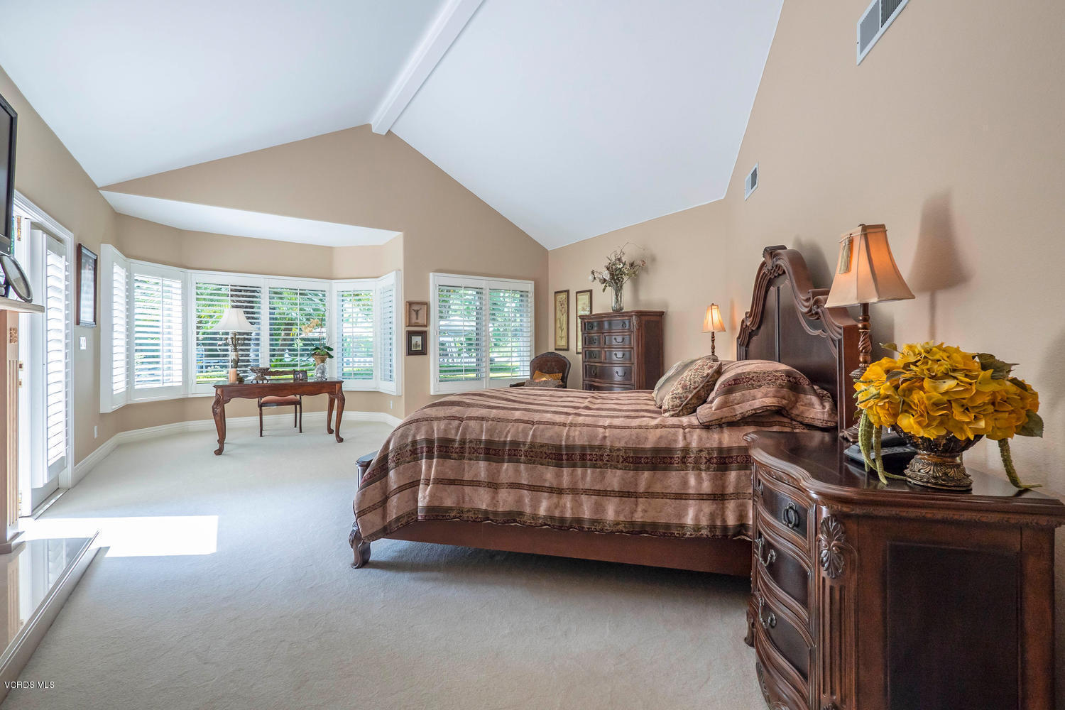 11112 Red Barn Road Camarillo, CA 93012 - Photo 25 of 54 a bedroom with a bed and a chandelier