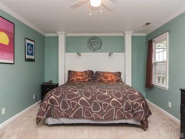 5116 Six Point Trail Raleigh, NC 27616 - Photo 16 of 18 a large bed sitting in a bedroom next to a window