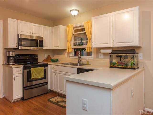 5116 Six Point Trail Raleigh, NC 27616 - Photo 18 of 18 a kitchen with stainless steel appliances a stove microwave and sink