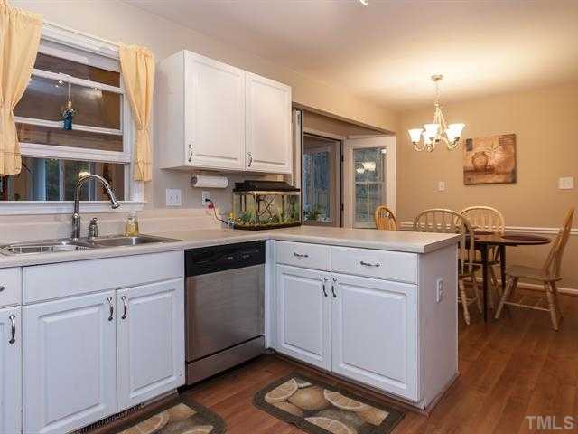 5116 Six Point Trail Raleigh, NC 27616 - Photo 3 of 18 a kitchen with a sink cabinets and wooden floor