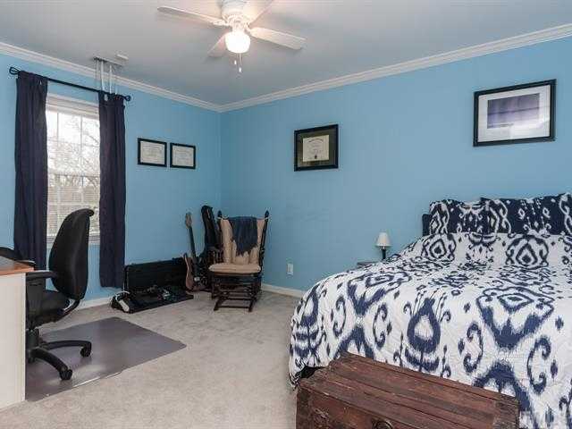 5116 Six Point Trail Raleigh, NC 27616 - Photo 9 of 18 a bedroom with a bed and chair