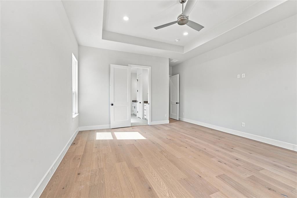 3820 Jack's Loop Midlothian, TX 76065 - Photo 19 of 40 Spacious room featuring wood-finish flooring, a tray ceiling, recessed lighting, and a ceiling fan