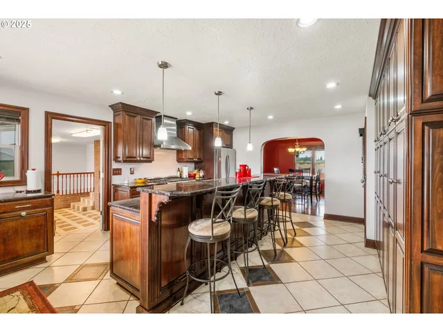 a kitchen with stainless steel appliances kitchen island granite countertop a sink and cabinets