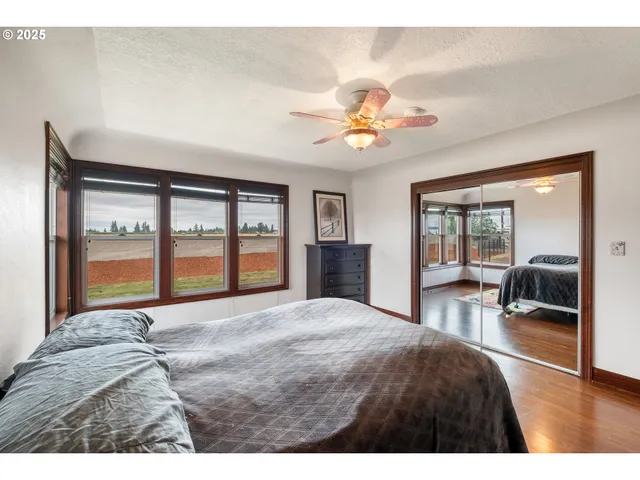 a bedroom with a large bed and a large window