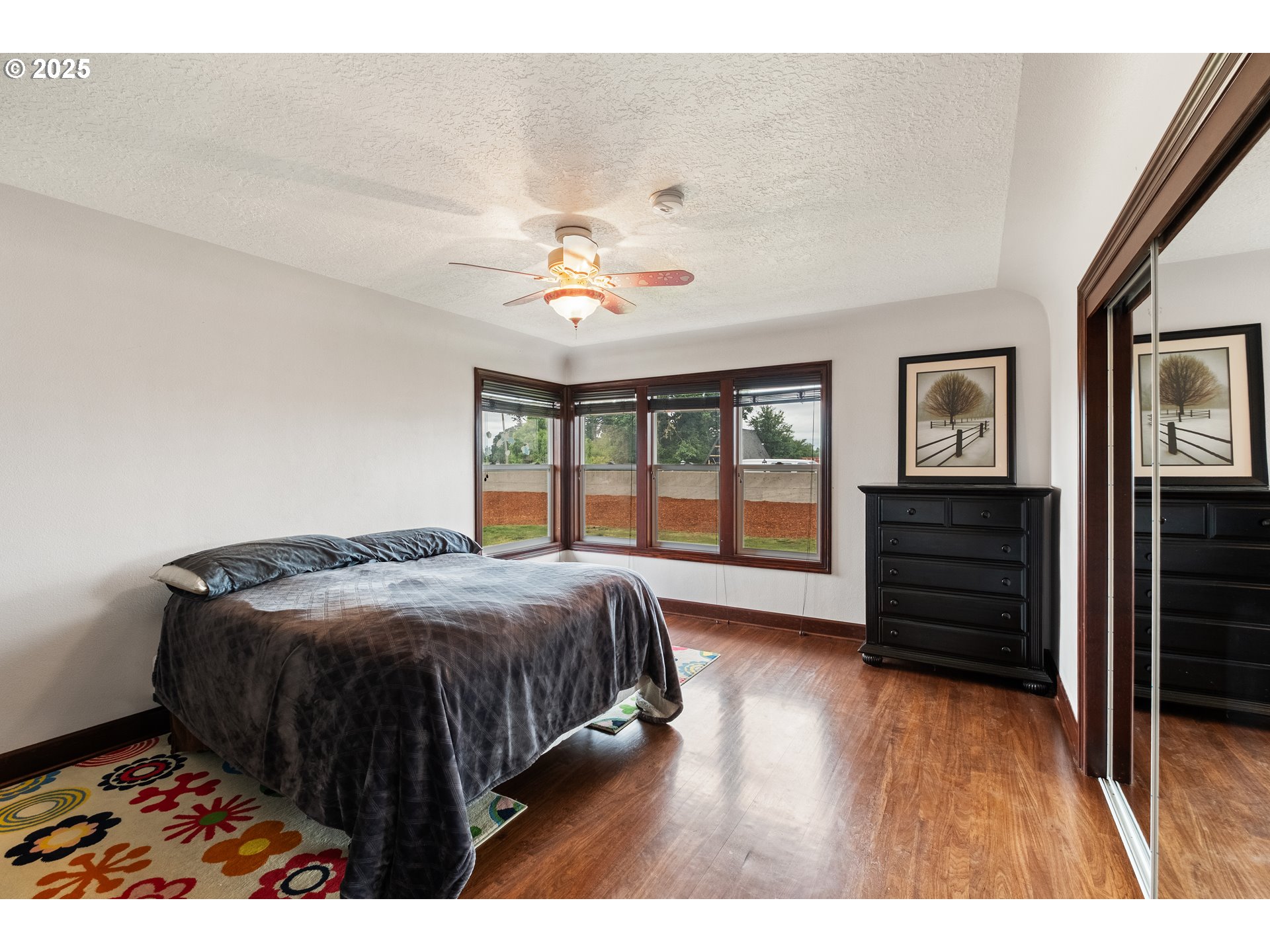 8758 Stayton Road Southeast Turner, OR 97392 - Photo 23 of 39 a bedroom with a bed a dresser and wooden floor