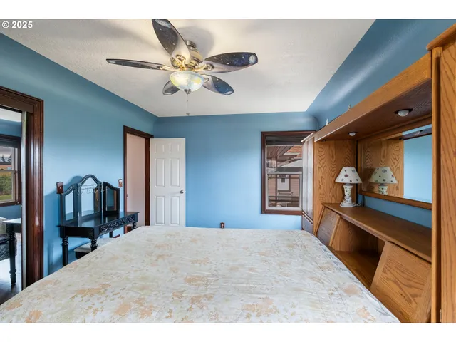 a bedroom with a bed and a large mirror