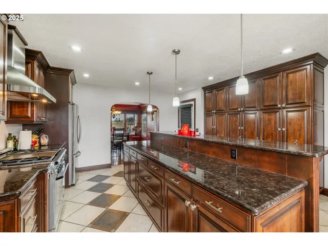 a kitchen with stainless steel appliances granite countertop a sink counter space and cabinets