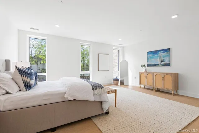 a bedroom with a bed a couch and dresser