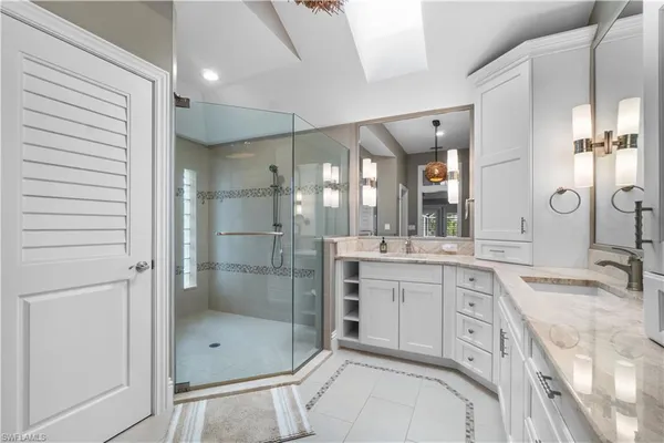 a bathroom with a granite countertop sink mirror and shower
