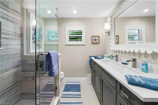 a bathroom with double vanity and a two mirror