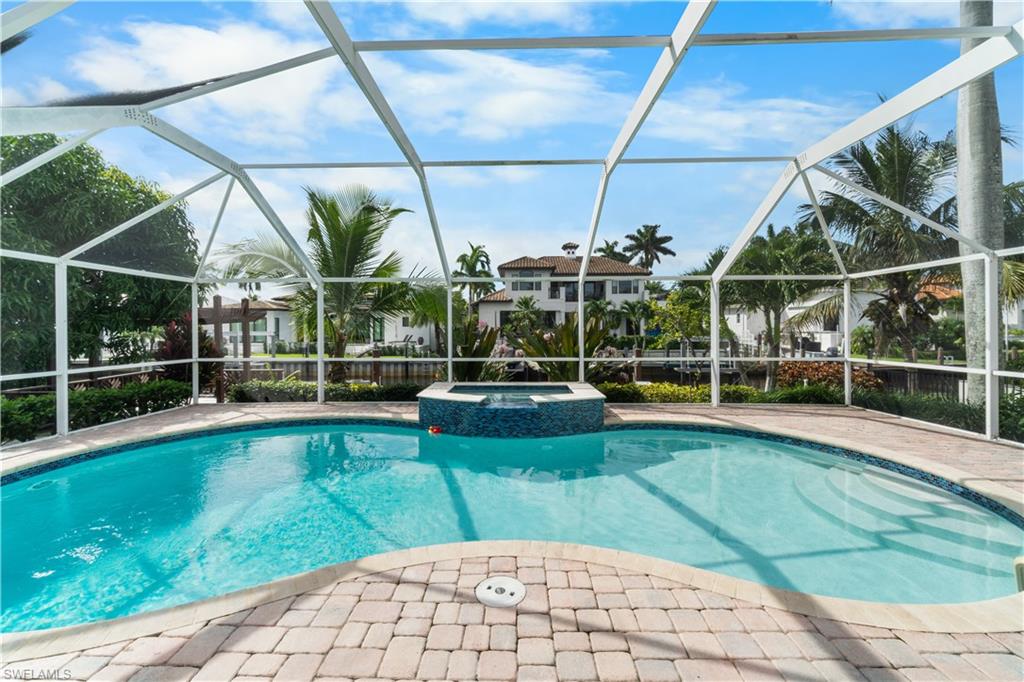 1320 Marlin Drive Naples, FL 34102 - Photo 24 of 33 a view of a swimming pool with a patio