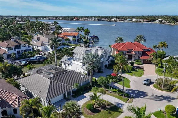 an aerial view of a house with a garden and lake view