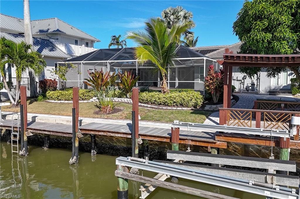 1320 Marlin Drive Naples, FL 34102 - Photo 32 of 33 a view of house with swimming pool and porch with furniture