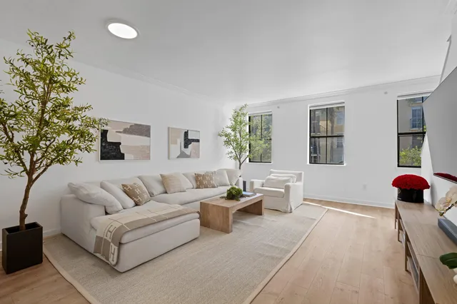 a living room with furniture and flowers