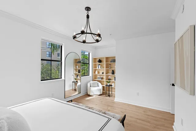 a bedroom with a bed and a chandelier