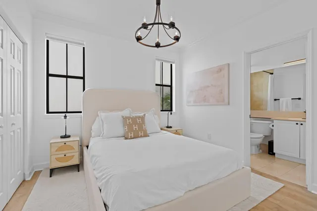 a bedroom with a bed and a chandelier