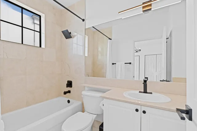 a bathroom with a sink a toilet and a bathtub