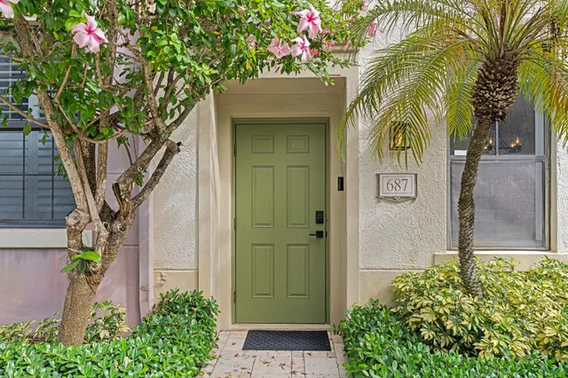 a front view of a house with a tree