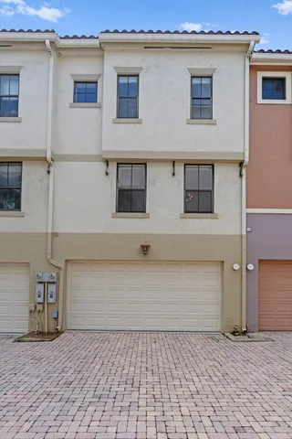 a view of a house with a yard and garage