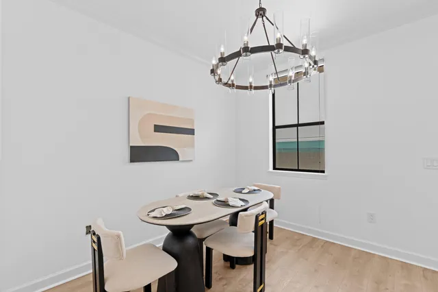a view of a dining room with furniture and chandelier