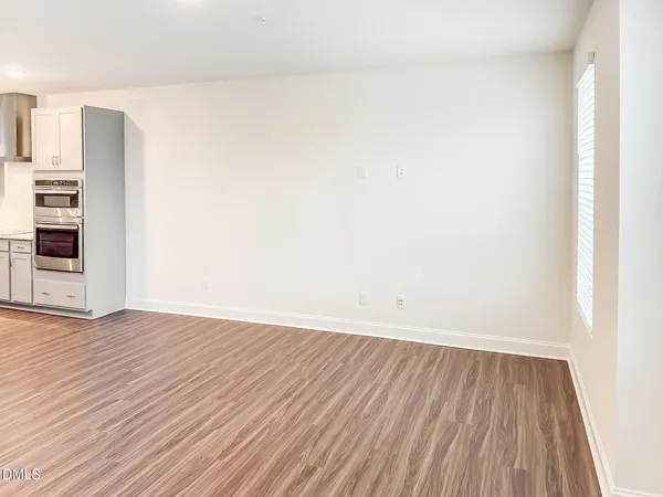 a dining hall with stainless steel appliances kitchen island granite countertop a refrigerator and a sink