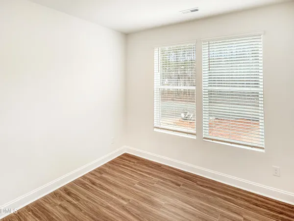 a living room with furniture a flat screen tv and a potted plant