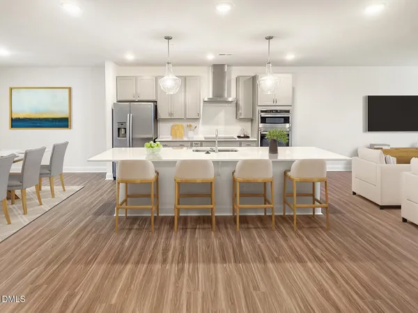 a large white kitchen with wooden floor