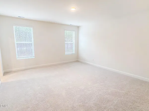 a bedroom with a bed and a potted plant