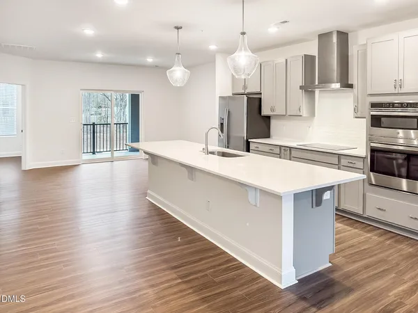 a kitchen with stainless steel appliances granite countertop a stove and a sink
