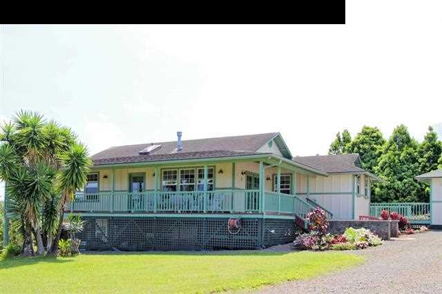 260 Awalau Road Haiku, HI 96708 - Photo 2 of 30 a front view of a house with a garden