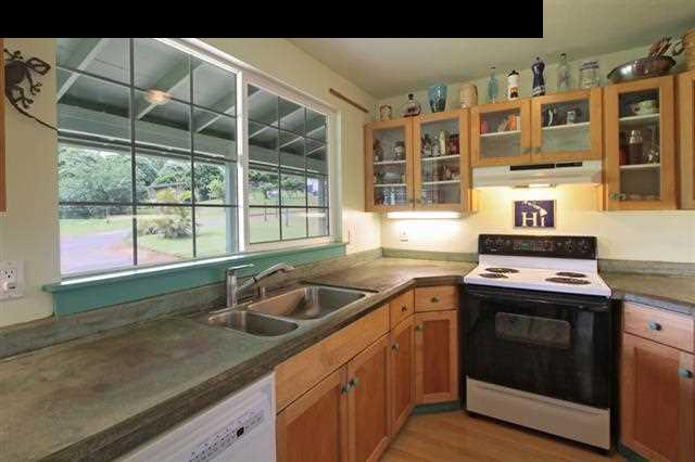 260 Awalau Road Haiku, HI 96708 - Photo 24 of 30 a kitchen with granite countertop a sink and a stove