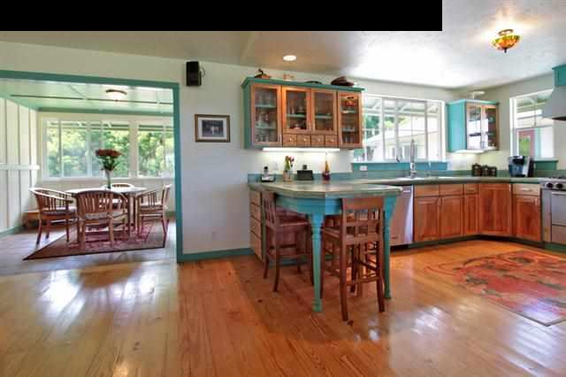 260 Awalau Road Haiku, HI 96708 - Photo 3 of 30 a kitchen with stainless steel appliances granite countertop a table and chairs in it