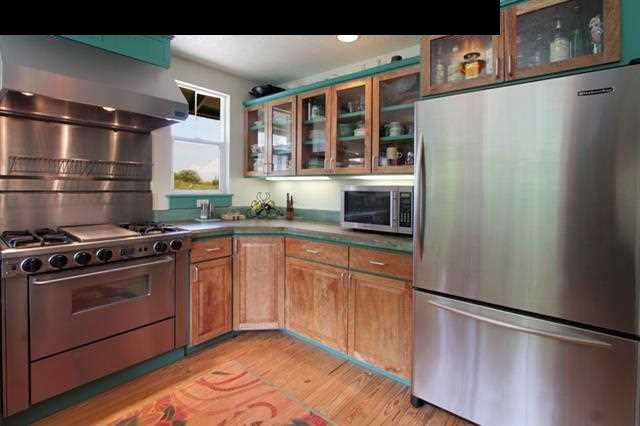 260 Awalau Road Haiku, HI 96708 - Photo 5 of 30 a kitchen with stainless steel appliances granite countertop a refrigerator and a sink