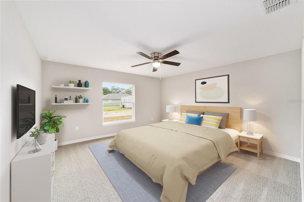 7866 North Manville Road Citrus Springs, FL 34434 - Photo 6 of 19 a bedroom with a bed couches and a flat tv screen