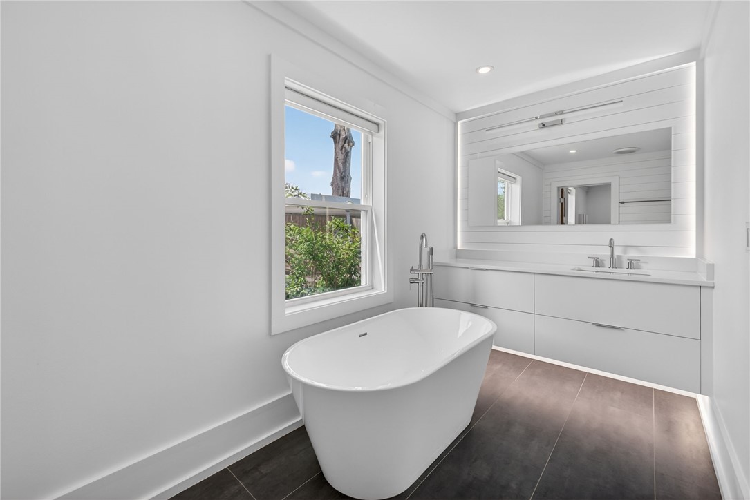 21 Haynes Street Piedmont, SC 29673 - Photo 11 of 35 This serene bathroom offers a spacious soaking tub and sleek vanity for ultimate relaxation.