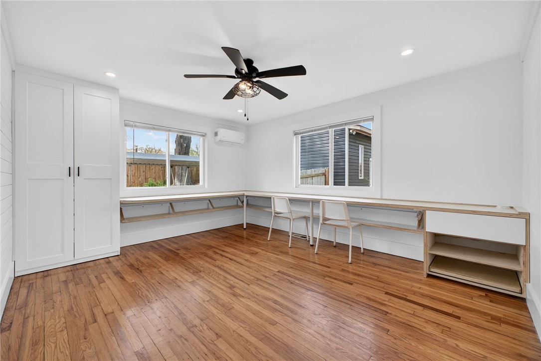 21 Haynes Street Piedmont, SC 29673 - Photo 13 of 35 This spacious room features rich hardwood flooring and built-in desk space, ideal for productivity.