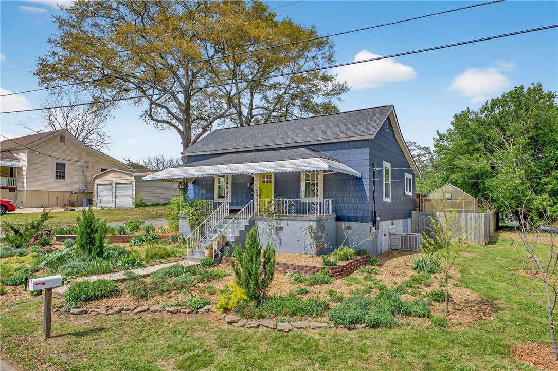 21 Haynes Street Piedmont, SC 29673 - Photo 2 of 35 This charming home offers a cozy front porch, vibrant landscaping, and a welcoming entrance.