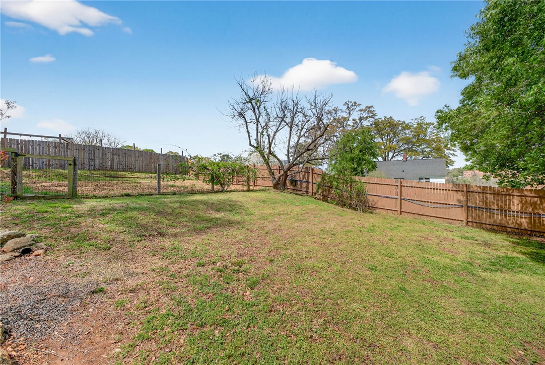 21 Haynes Street Piedmont, SC 29673 - Photo 27 of 35 This spacious yard offers ample outdoor living potential, featuring both wood and chain link fencing.