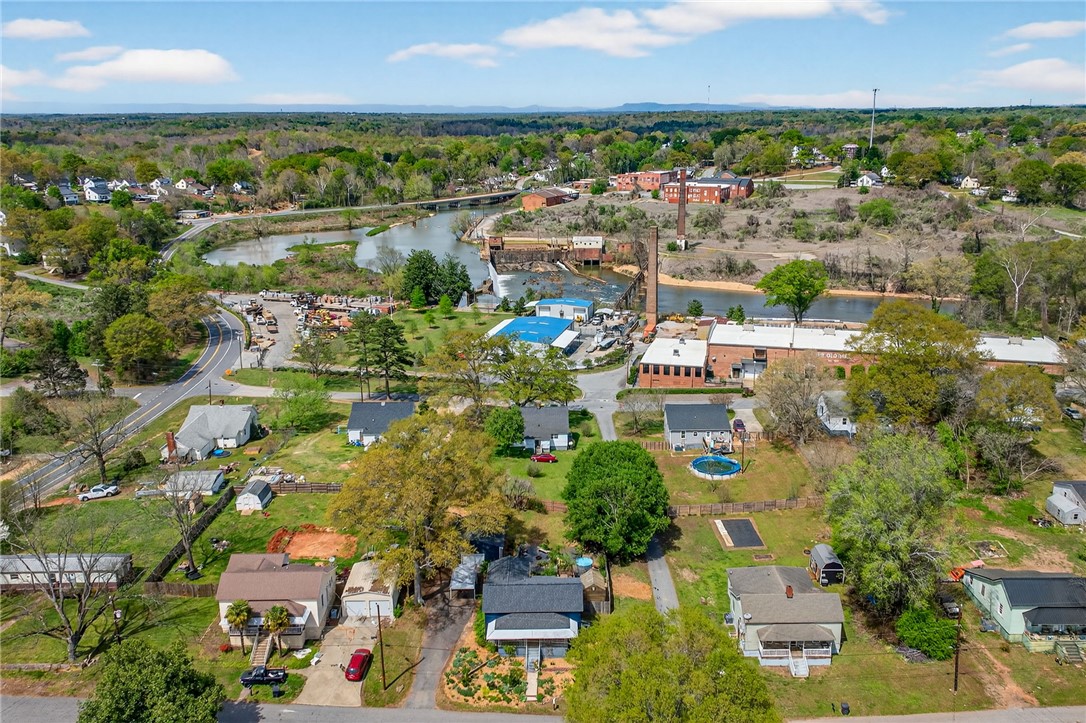 21 Haynes Street Piedmont, SC 29673 - Photo 30 of 35 An aerial view showcases a residential area nestled alongside a winding river.