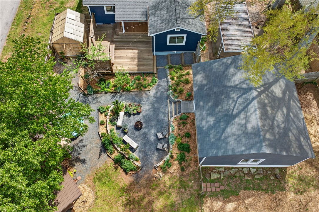 21 Haynes Street Piedmont, SC 29673 - Photo 32 of 35 An aerial view captures the outdoor space, highlighting a fire pit and a raised wooden deck.