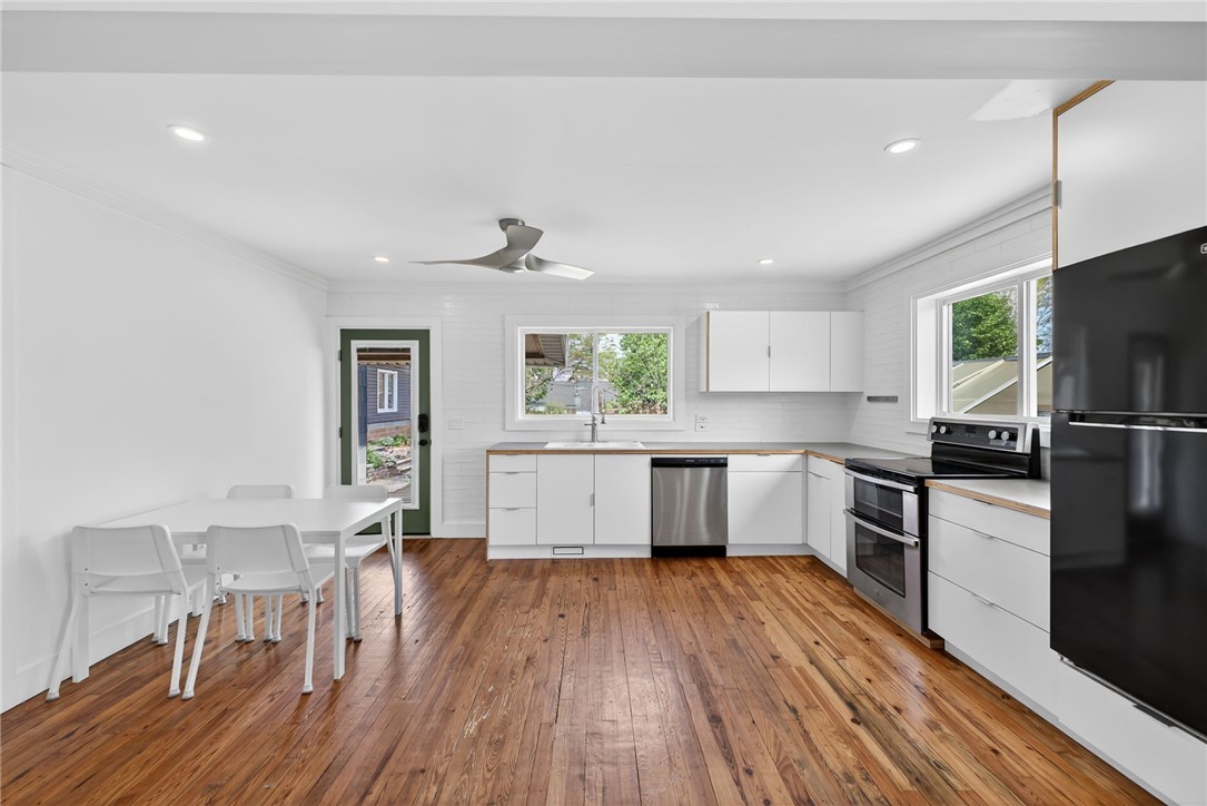 21 Haynes Street Piedmont, SC 29673 - Photo 7 of 35 This bright kitchen features wood flooring, modern appliances, and a convenient layout.