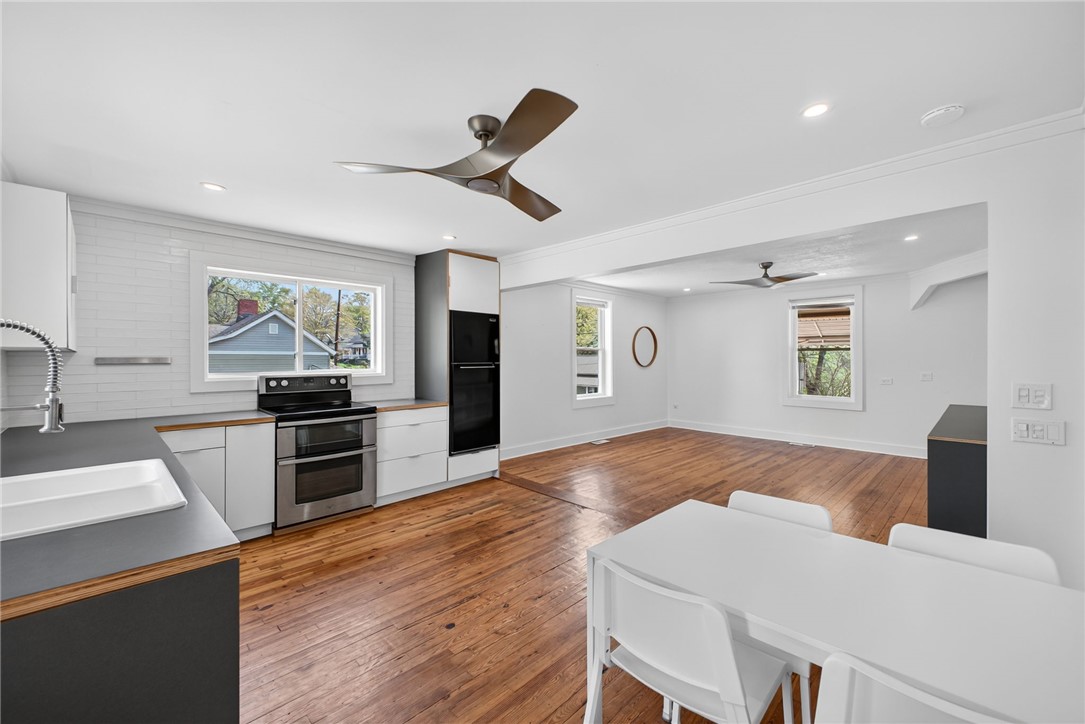 21 Haynes Street Piedmont, SC 29673 - Photo 8 of 35 This bright, open-concept living space boasts wood floors and abundant natural light, ideal for entertaining.