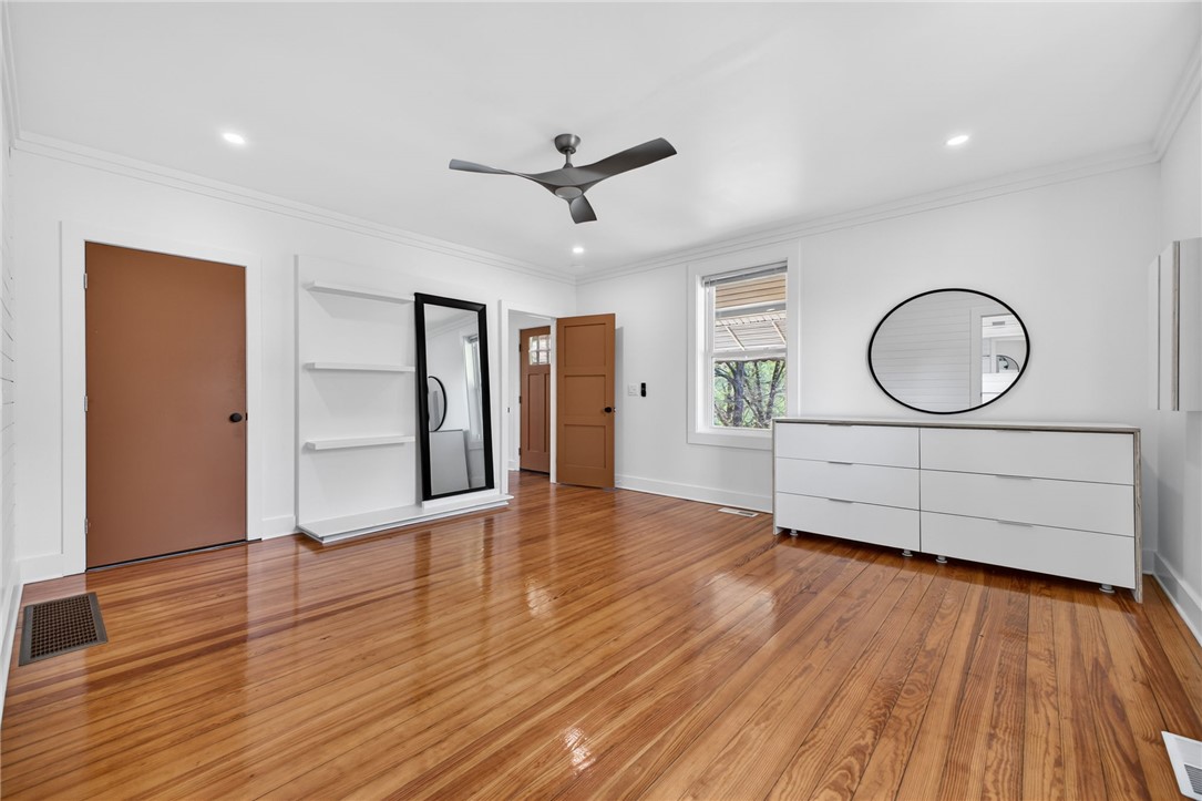 21 Haynes Street Piedmont, SC 29673 - Photo 10 of 35 This spacious bedroom features warm hardwood floors and abundant natural light.