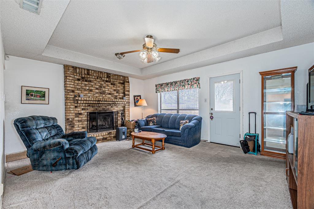 108 Cole Road Red Oak, TX 75154 - Photo 12 of 30 a living room with furniture a fireplace and a flat screen tv