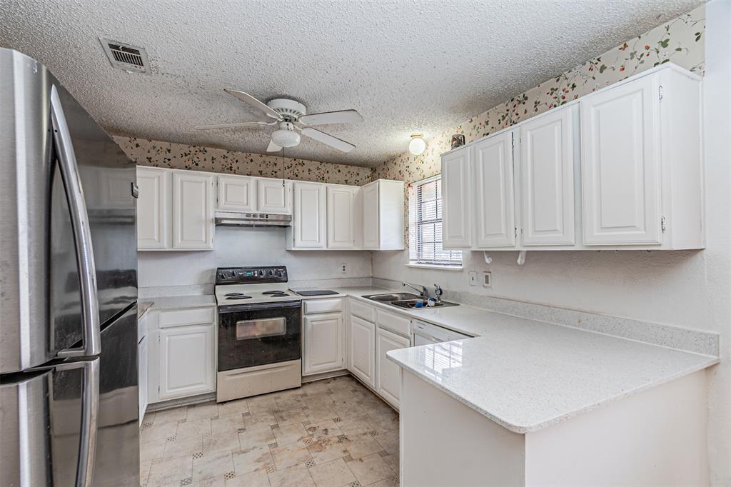 108 Cole Road Red Oak, TX 75154 - Photo 16 of 30 a kitchen with stainless steel appliances granite countertop a sink a stove a refrigerator and cabinets