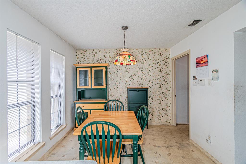 108 Cole Road Red Oak, TX 75154 - Photo 20 of 30 a dining room with furniture a fireplace and a chandelier