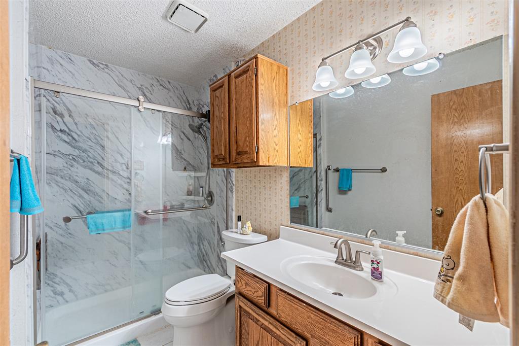 108 Cole Road Red Oak, TX 75154 - Photo 27 of 30 a bathroom with a sink vanity granite toilet and shower