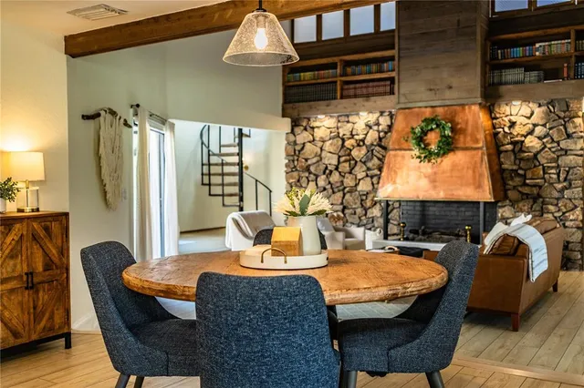 a livingroom with furniture a rug a flat screen tv and couches