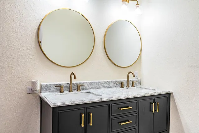 a view of a lake with a table and chairs in the patio